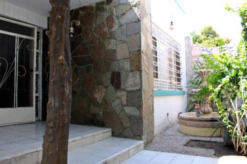 a building with a stone wall and stairs outside at Hermosa Casa en Ciudad Lerdo con 2 Habitaciones in Ciudad Lerdo