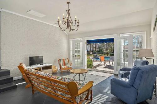 a living room with a couch and a chandelier at Cypress Grove - Dog River in Mobile