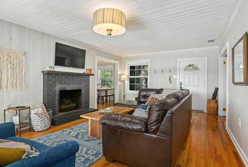 a living room with a couch and a fireplace at Cypress Grove - Dog River in Mobile