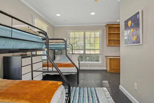 a room with three bunk beds and a kitchen at Cypress Grove - Dog River in Mobile