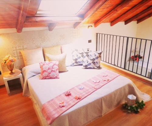 a bedroom with a large bed with flowers on it at A Trecastagni - Etna Home in Trecastagni