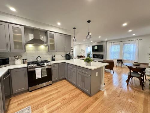 a kitchen with stainless steel appliances and a dining room at Home Away From Home in Lowell in Lowell