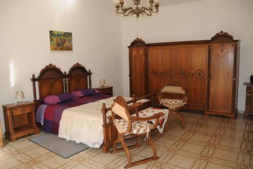 a bedroom with a bed and wooden furniture at App. Biancavilla Catania I in Biancavilla