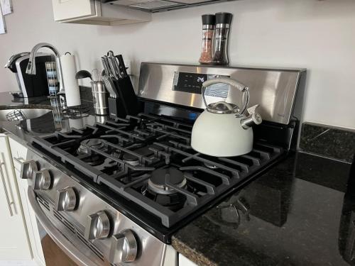 a kitchen stove with a tea kettle on it at Modern, All New 3BR Near UMASS in Lowell