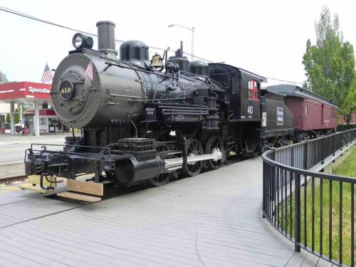 an old black train on display next to a fence at Modern, All New 3BR Near UMASS in Lowell