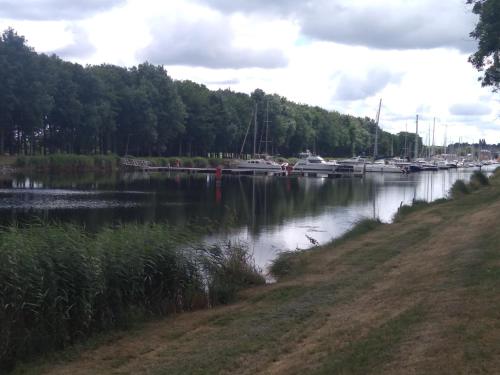 a body of water with boats docked in it at chambre carentan les marais aux calme très reposant in Saint-Hilaire-Petitville
