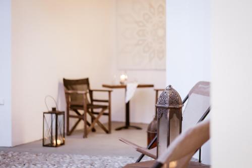 a living room with a table and chairs at Utopia Luxury Suites - Old Town in Rhodes Town