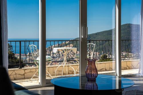 a vase sitting on a glass table on a balcony at Ventus Rosa Villa in Budva