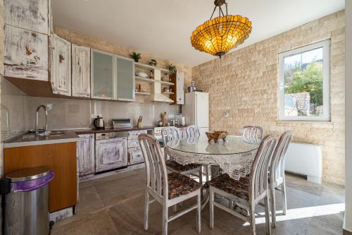 a kitchen with a table and chairs in a room at Ventus Rosa Villa in Budva
