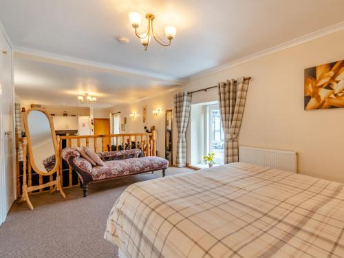 a bedroom with a bed and a mirror at 1 Bed in Newton Stewart DF198 in Newton Stewart