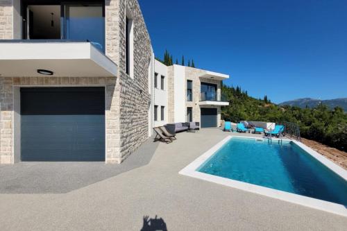 a villa with a swimming pool and a house at Bay View Village -Villa Eléanora 4 in Herceg-Novi
