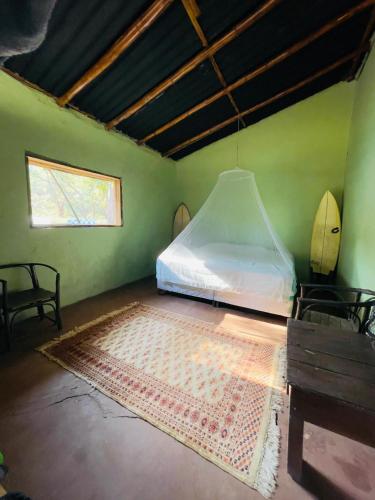 a bedroom with a bed and a rug on the floor at Bongo Experience in Jucuarán