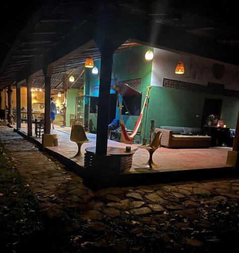a room with a hammock and a playground at night at Bongo Experience in Jucuarán