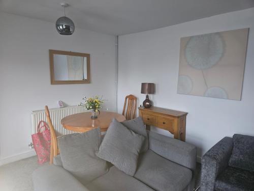 a living room with a couch and a table at Cwmynyscoy Cottage Pontypool NP4 5SQ in Pontypool