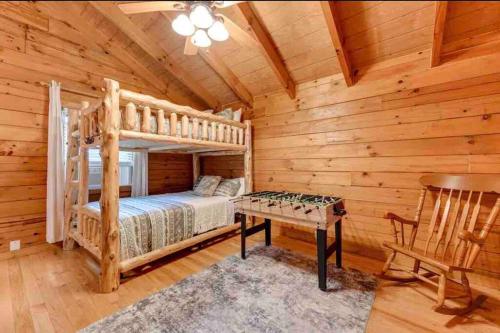 a bedroom with a bunk bed and a desk in a cabin at Clover Creek Cabin in Waynesville