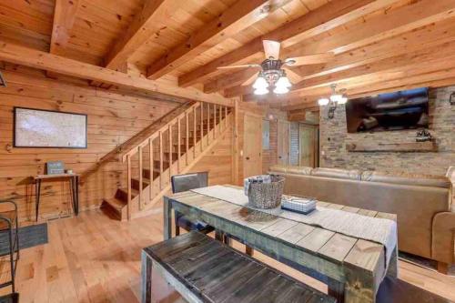 a log cabin living room with a wooden ceiling at Clover Creek Cabin in Waynesville