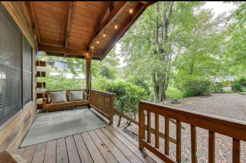 a porch of a home with a wooden deck at Clover Creek Cabin in Waynesville