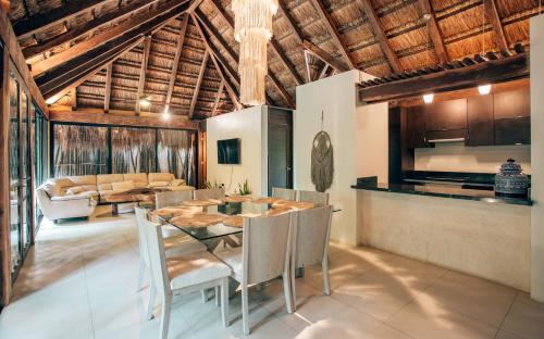 a kitchen and dining room with a table and chairs at Orchid House Tulum Jungle in Tulum