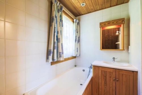 une salle de bain avec une baignoire et un lavabo dans l'établissement Les Chalets de Flaine Hameau - maeva Home - Chalet 4 Pièces 8 Personnes - Confort MAE-3662, à Flaine