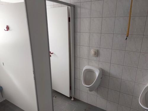 a bathroom with a urinal and two urinals at Gasthof Oberschmiede in Auf der Wiese