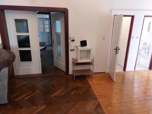 a living room with a wooden floor and a mirror at Gasthof Oberschmiede in Auf der Wiese