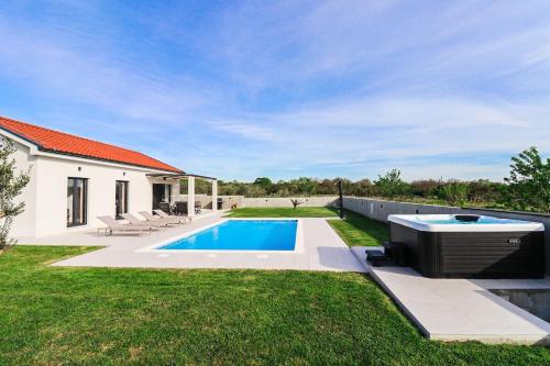 a swimming pool in the yard of a house at Villa Gemini in Zadar