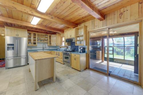 a large kitchen with wooden walls and a wooden ceiling at Spacious Pinedale Home with Mountain Range View in Pinedale