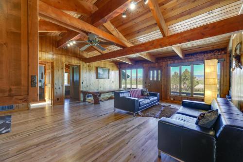 a living room with couches and a wooden ceiling at Spacious Pinedale Home with Mountain Range View in Pinedale