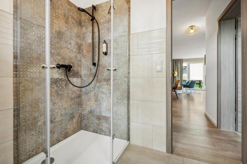 um chuveiro com uma porta de vidro na casa de banho em NEU! Design-FeWo Heidetraum em Bad Fallingbostel