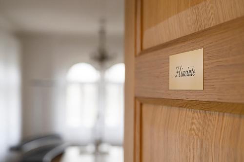 a close up of a door with a sign on it at Villa Langberg Spa in Ventspils