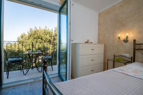 a bedroom with a bed and a balcony at Beautiful Villa Libero with a pool jacuzzi sauna in Makarska