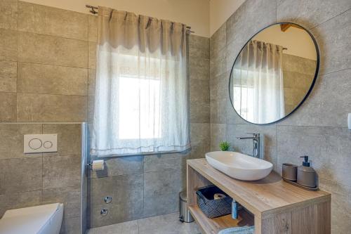 a bathroom with a sink and a mirror at Villa Milly Groznjan in Grožnjan