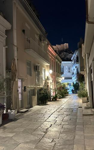 an empty street in a town at night at Central House in Plaka in Athens