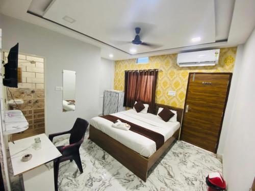 a hotel room with a bed and a bathroom at Seven star in Indore