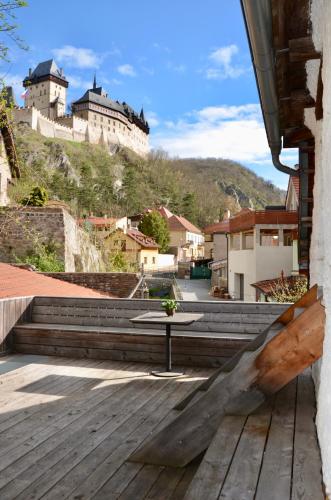 a table on a deck with a castle in the background at Karlštejn 34 in Karlštejn