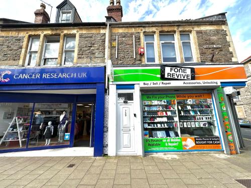 two store fronts on a street in front of a building at DVM escape Flat 3 in Bristol
