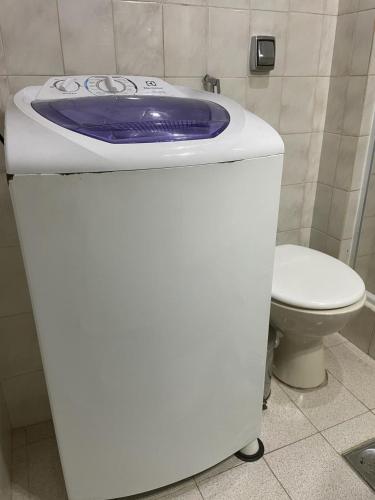 a bathroom with a toilet and a purple frisbee on a counter at Studio Copacabana Ipanema in Rio de Janeiro