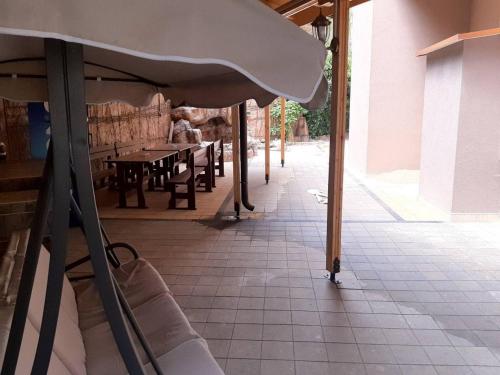 a patio with a table and chairs in a building at Апартамент "ИЛИЕВИ" in Obzor