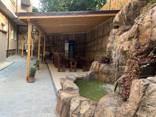 a patio with a small pond with a waterfall at Апартамент "ИЛИЕВИ" in Obzor