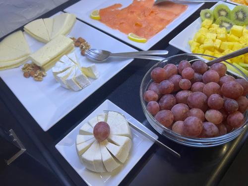 a table topped with different types of cheese and fruit at Hotel Aatu - Adults Only in Peratallada