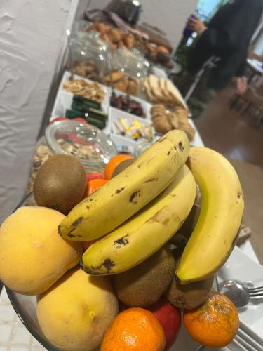 a bowl of fruit with bananas and other foods at Hotel Aatu - Adults Only in Peratallada