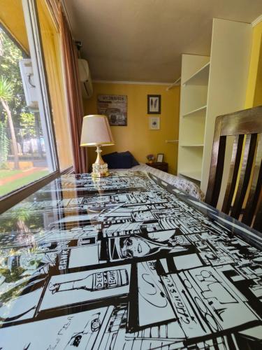 a table with a black and white drawing on it at Hostal Pucara Molina in Molina