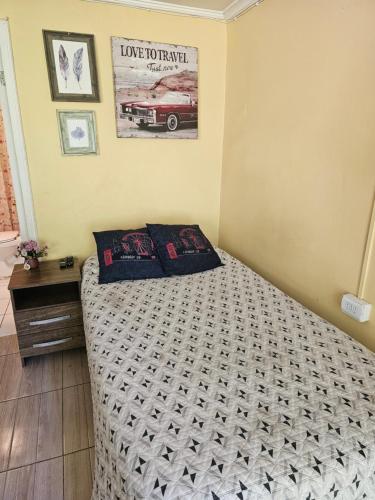 a bedroom with a bed and a picture on the wall at Hostal Pucara Molina in Molina