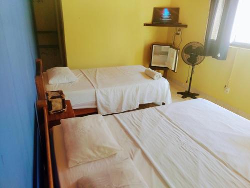 a hospital room with two beds and a fan at Punta Pacífico Bungalows Máncora in Máncora