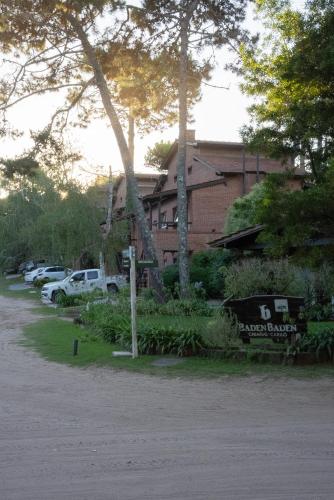 a parking lot with cars parked in front of a building at Baden Baden Carilo in Carilo