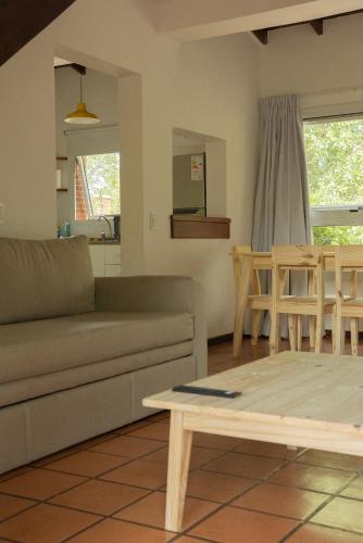 a living room with a couch and a table at Baden Baden Carilo in Carilo