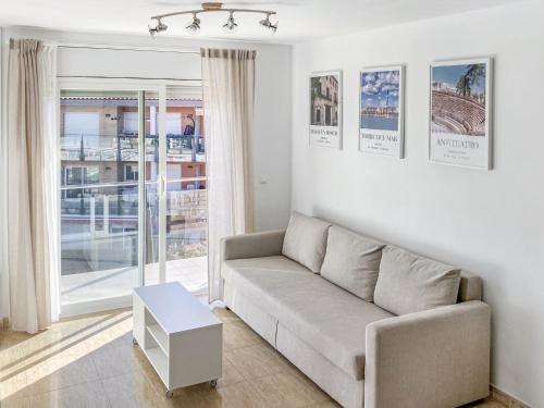 a living room with a couch and a table at Apartamento Port Marino in Cambrils