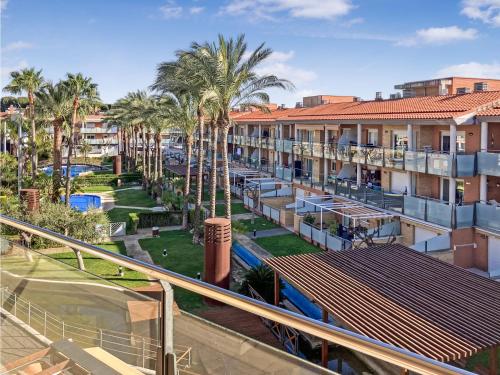 arial view of a resort with palm trees and buildings at Apartamento Port Marino in Cambrils