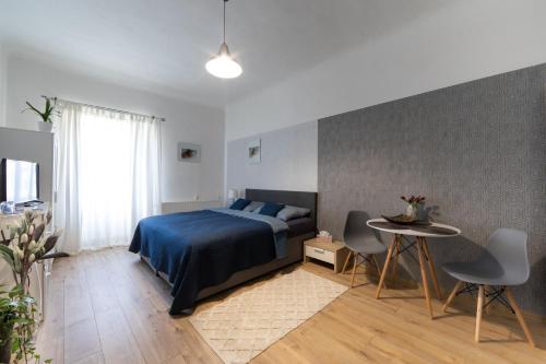 a bedroom with a bed and a table and chairs at Ubytování v centru in Lanškroun