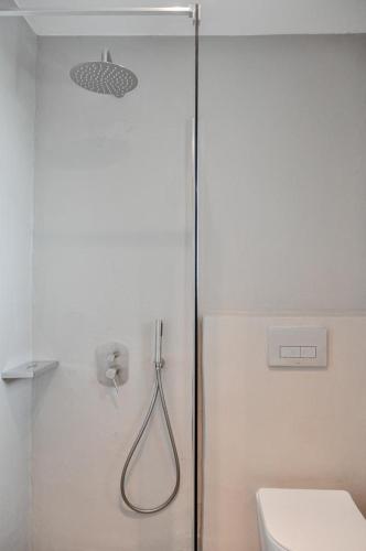 a shower in a bathroom with a toilet at Cliff Villa in Sarakíniko